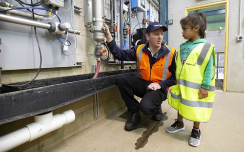 Watercare process technician Scott Llewelyn with young visitor, Tumairangi Hancy.