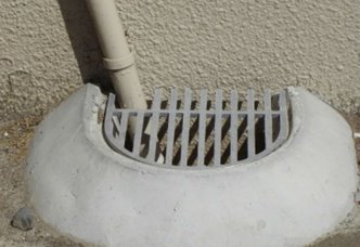Image of a downpipe and gully trap